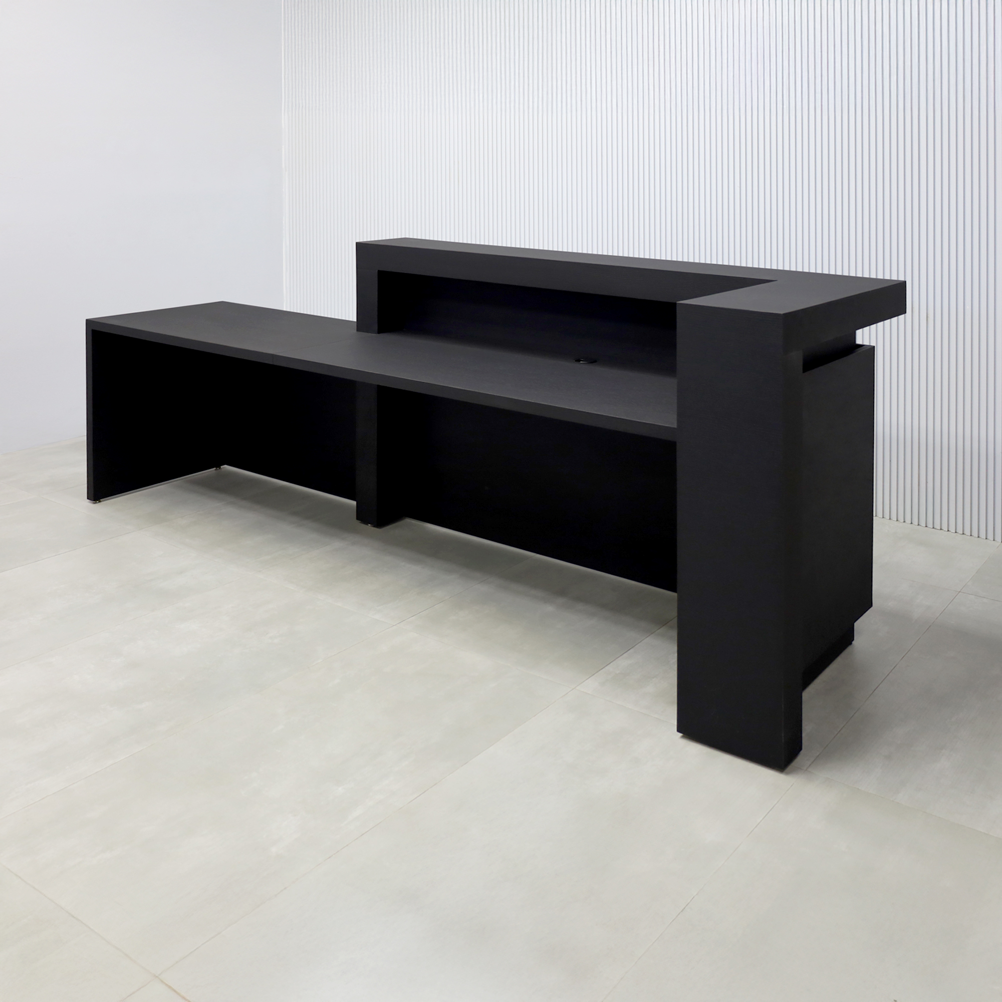 108-inch New York L ADA Reception Desk with Black Cinder Matte laminate desk, Black Cinder matte laminate workspace, Black Cinder matte laminate front panel, and Warm White LED with remote control.