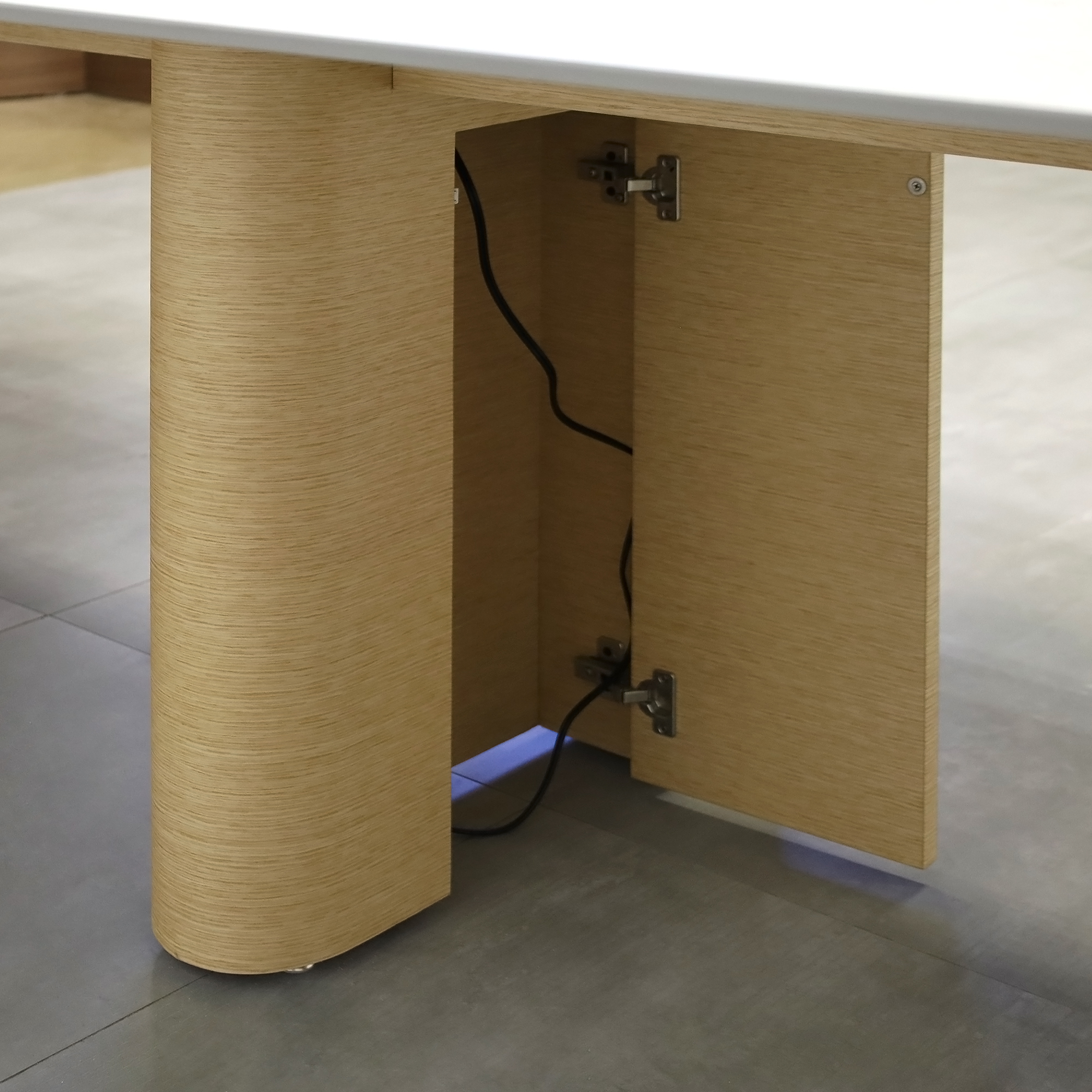 144-inch Aurora Racetrack Conference Table with 1/2" Positano engineered surface(Special Finish) top, White Oak veneer base, and two Silver Mx3 power boxes.