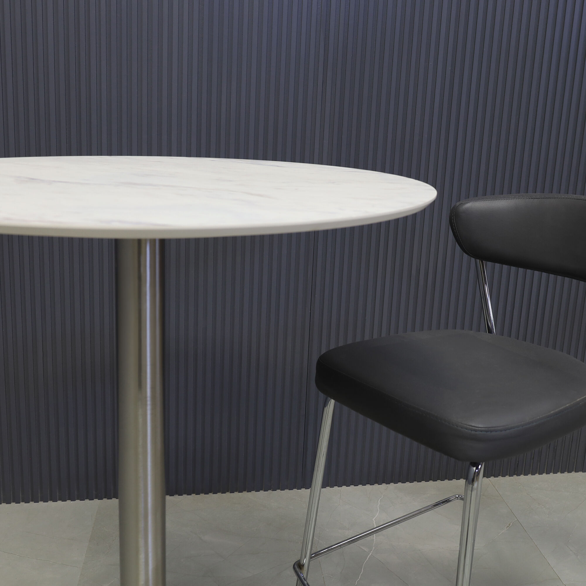 24-inch California Round Engineered Surface Bar Table in 1/2" calcutta blanc engineered surface and brushed stainless steel base, shown here.