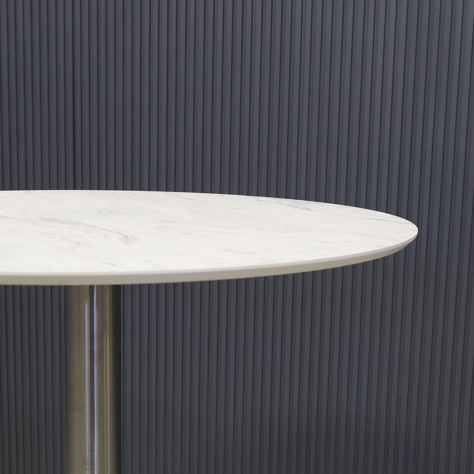 24-inch California Round Engineered Surface Bar Table in 1/2" calcutta blanc engineered surface and brushed stainless steel base, shown here.