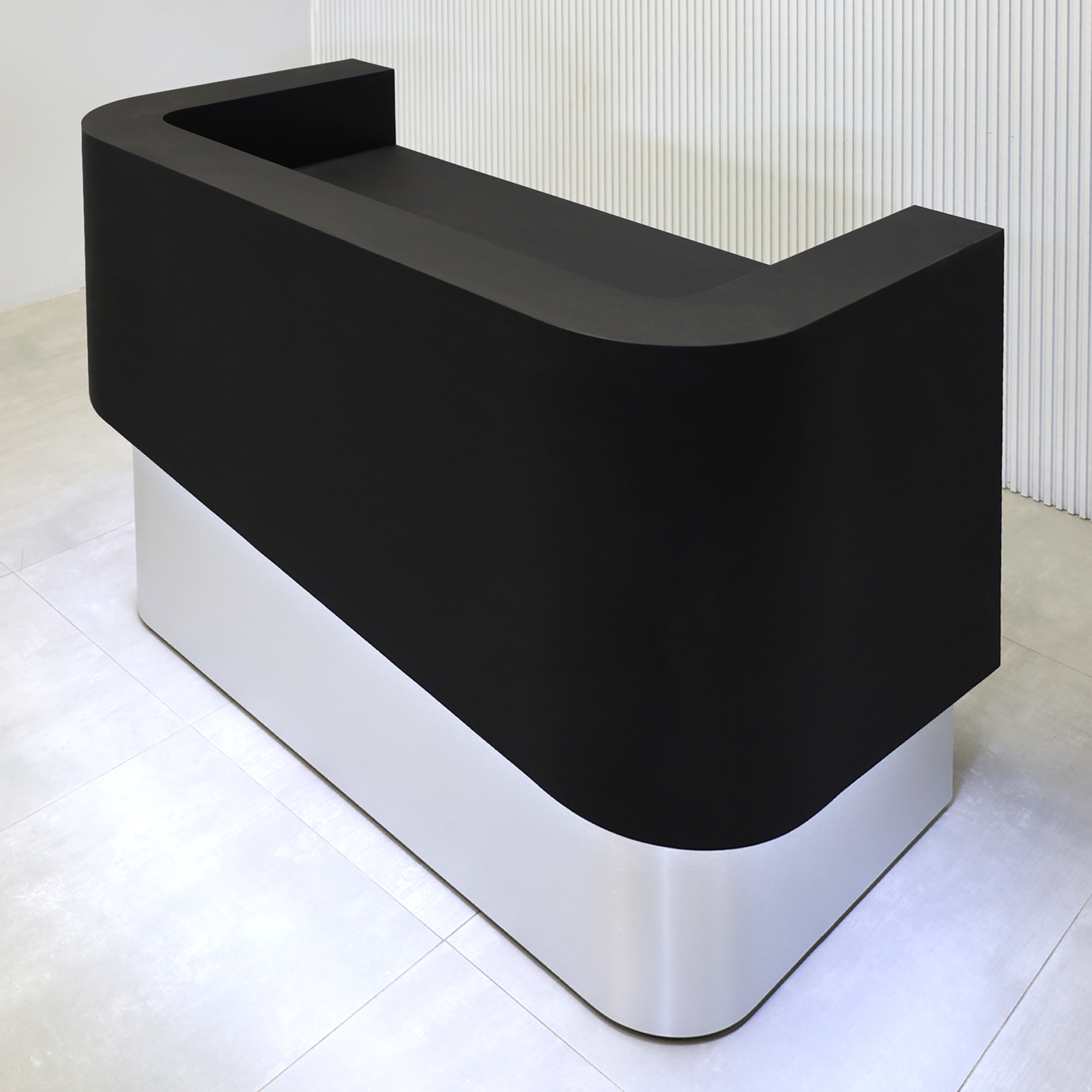 60-inch Nola Curved Reception Desk with Black Cinder matte laminate counter, Black Cinder matte laminate workspace, Brushed Aluminum base, and White LED.