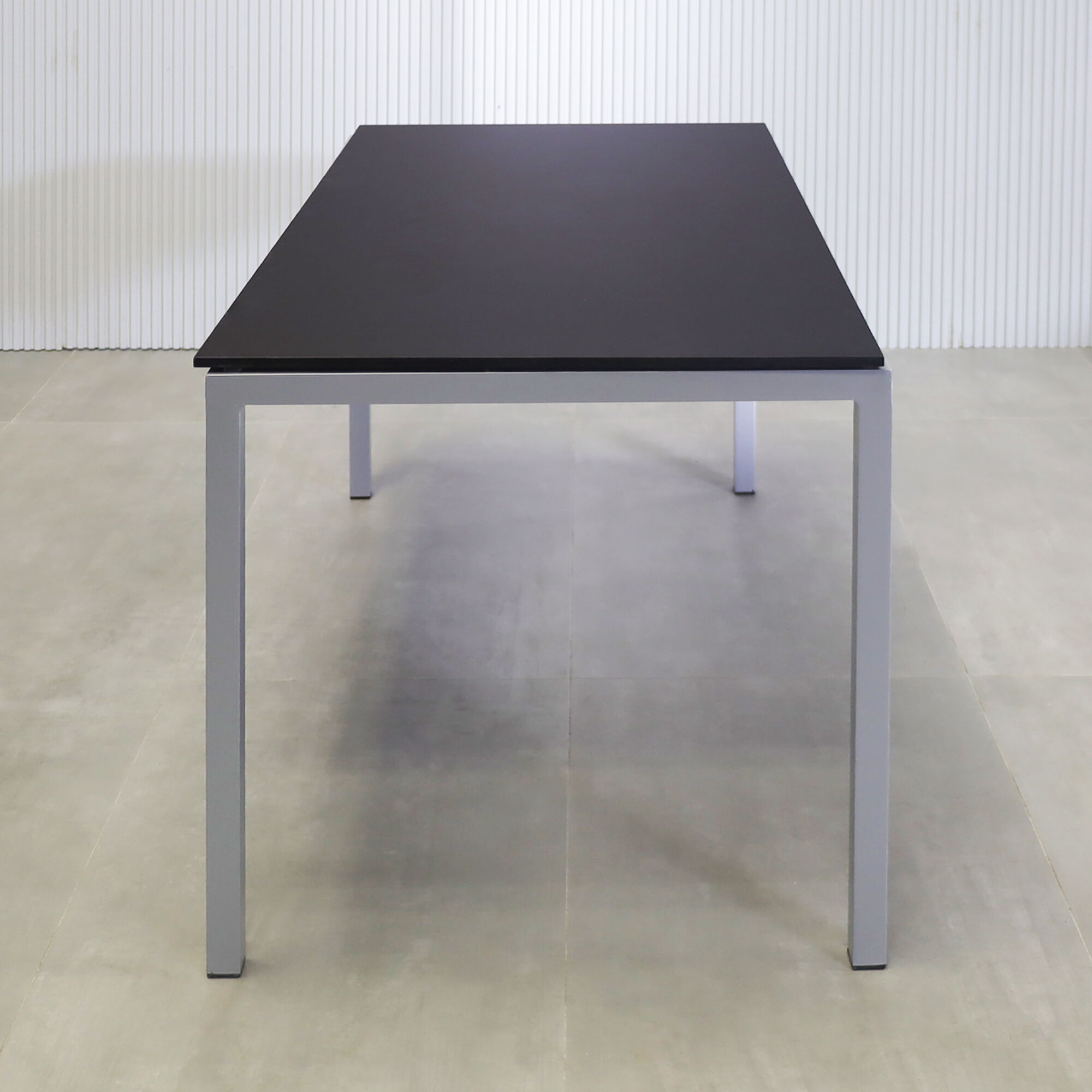 60-inch Aspen Rectangular Conference Table in 1/2" black traceless engineered surface top, and metal powder coated silver base.