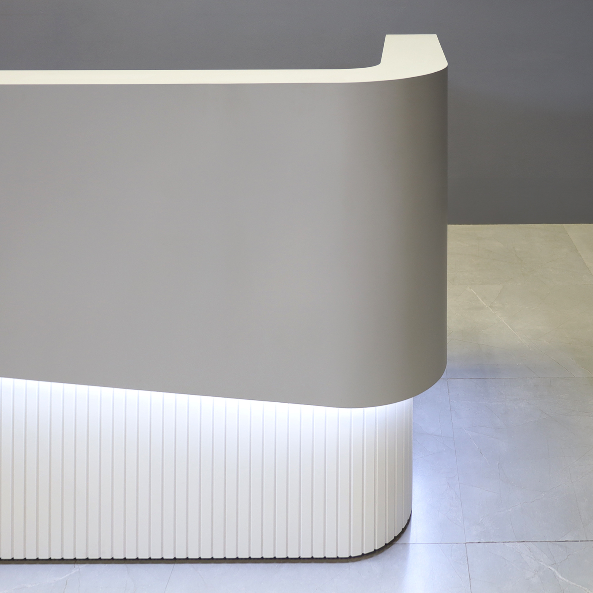 60-inch Nola Curved Custom Reception Desk in folkstone gray matte laminate counter & inside desk, white matte tambour front desk, and warm white LED.