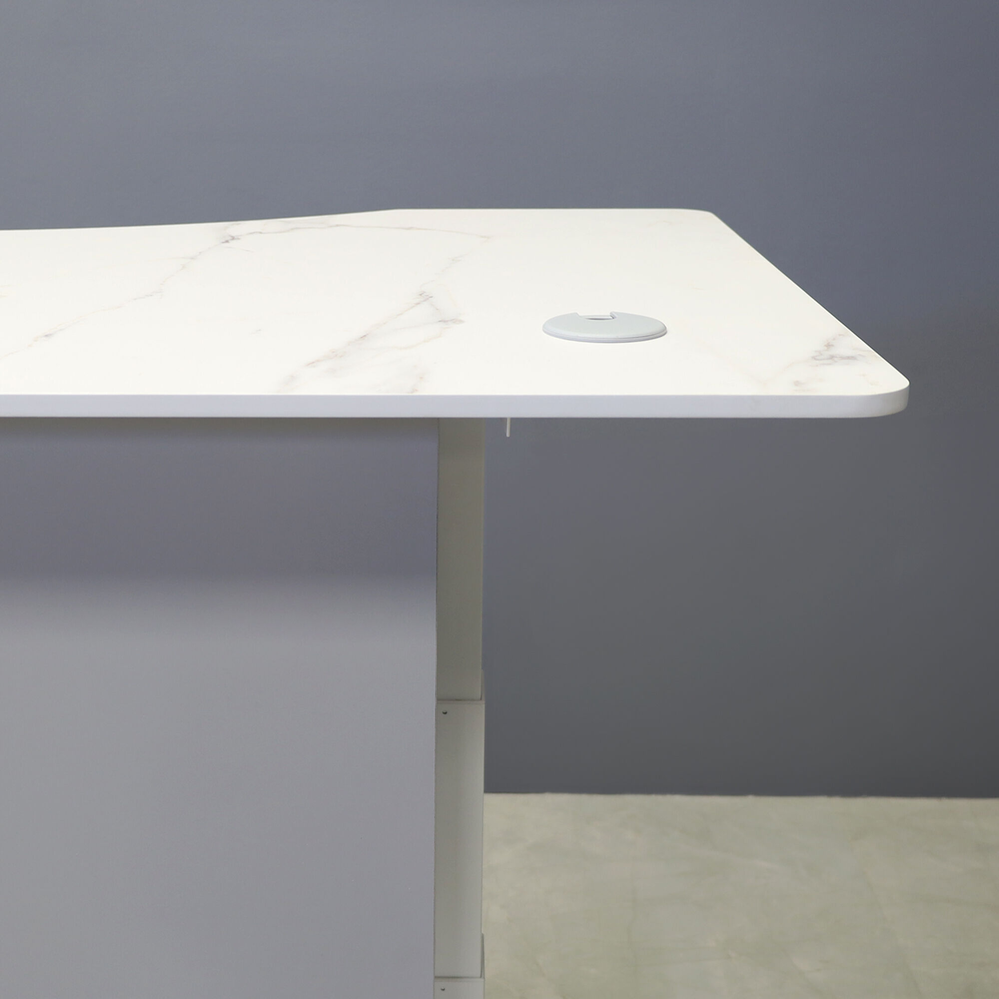 60-inch aXis Sit-stand Executive Desk with 1/2" solenne marble engineered surface top, folkstone gray matte laminate privacy panel and white metal legs shown here.