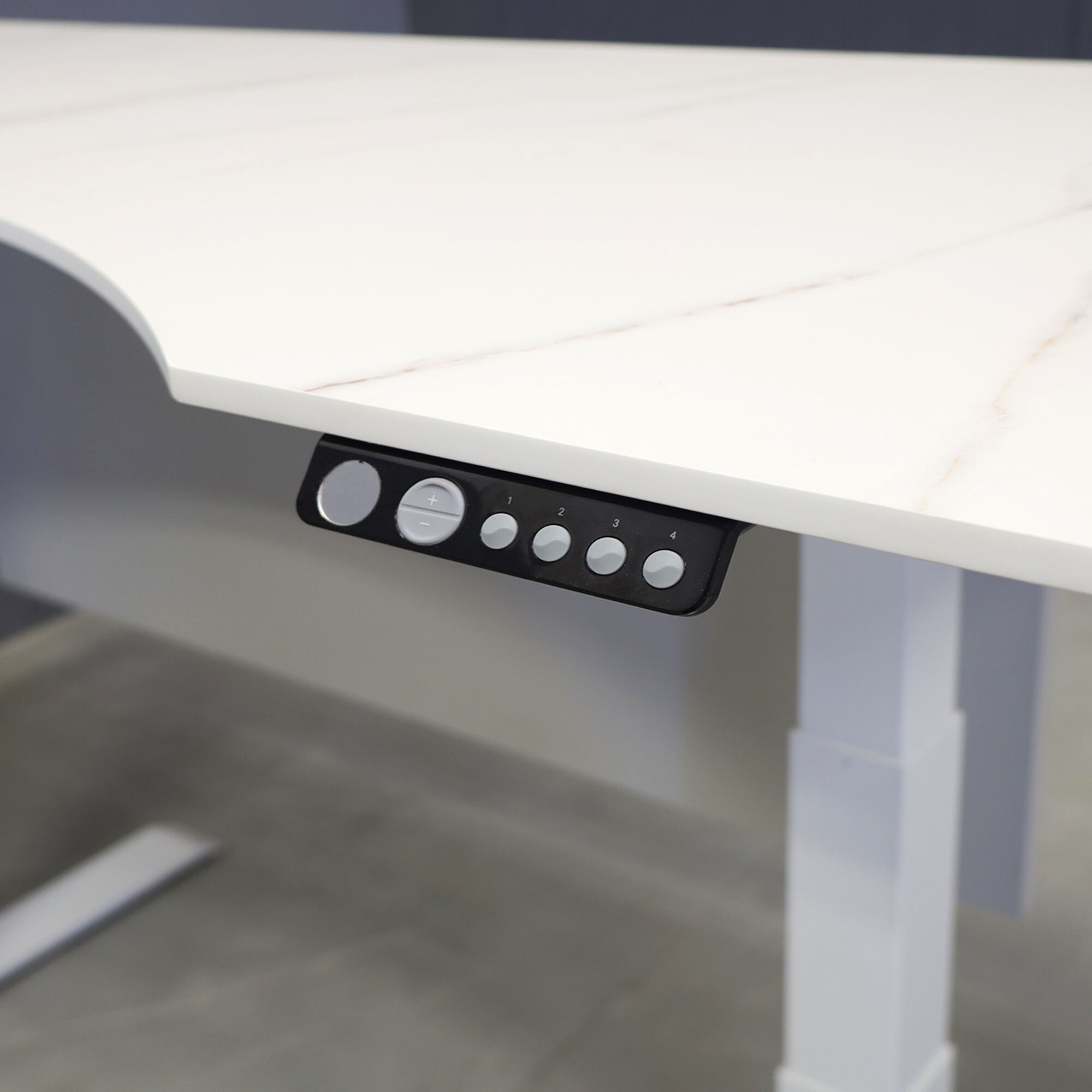 60-inch aXis Sit-stand Executive Desk with 1/2" solenne marble engineered surface top, folkstone gray matte laminate privacy panel and white metal legs shown here.