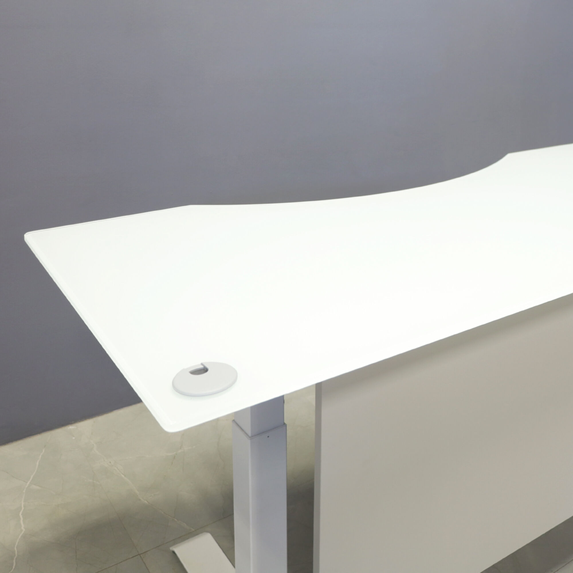 60-inch aXis Sit-stand Executive Desk with 1/2" white tempered glass top, folkstone gray matte laminate privacy panel and white metal legs, shown here.