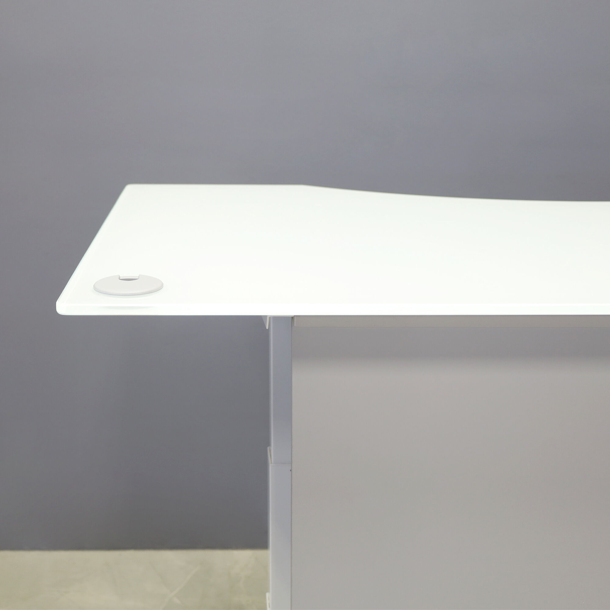 60-inch aXis Sit-stand Executive Desk with 1/2" white tempered glass top, folkstone gray matte laminate privacy panel and white metal legs, shown here.