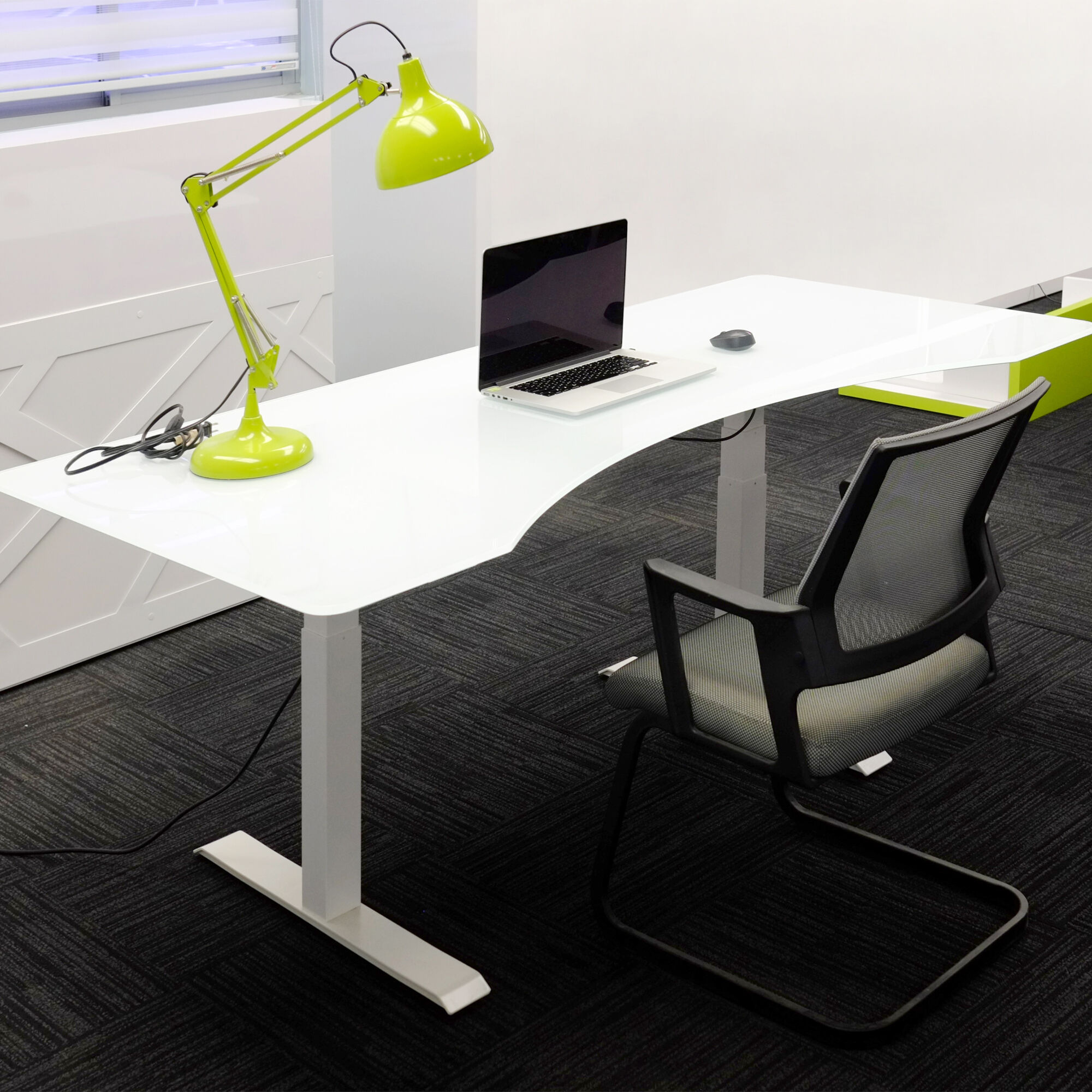 60-inch aXis Sit-stand Executive Desk with 1/2" white tempered glass top and white metal legs, shown here.