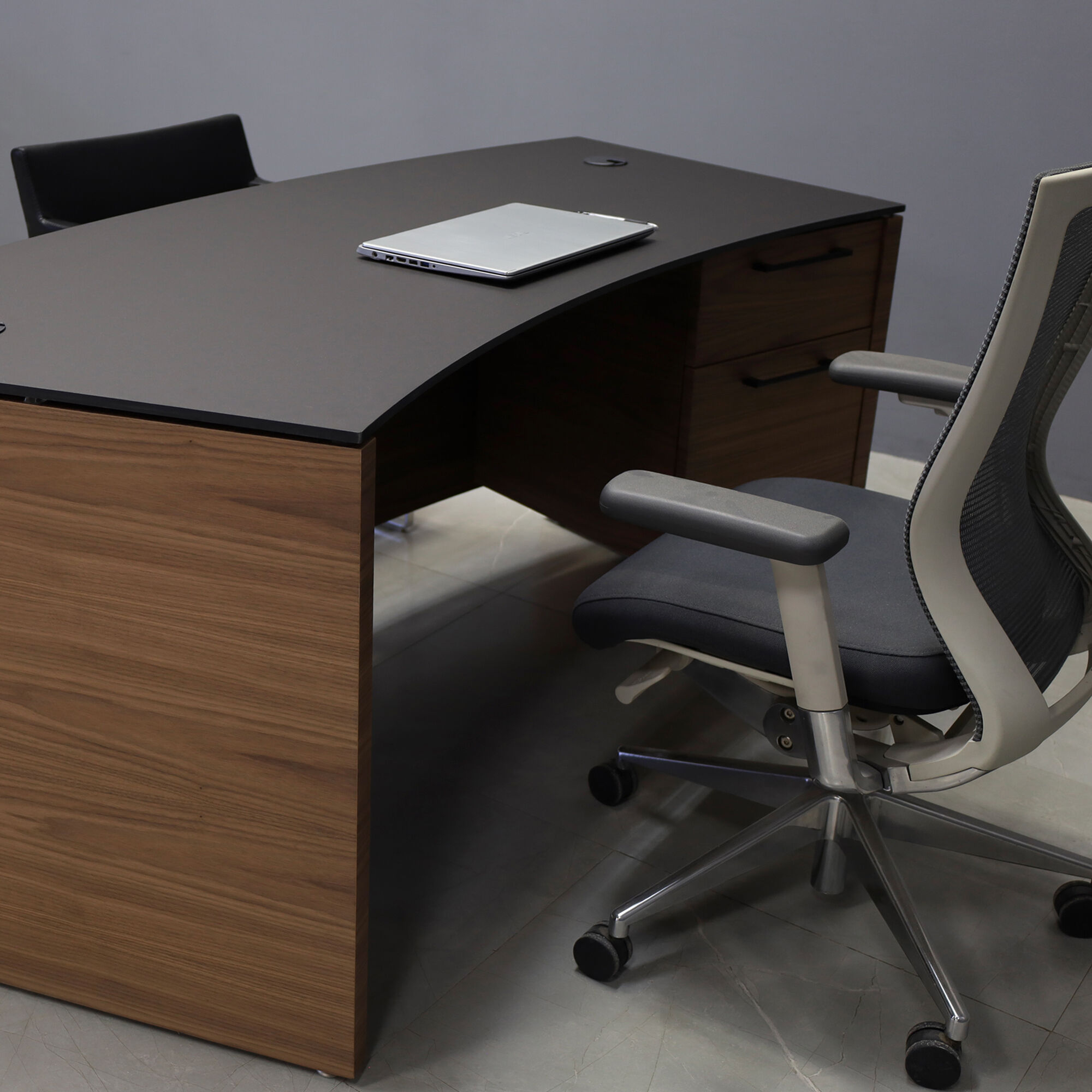 72-inch Seattle Curved Executive Desk with 1/2" Black traceless engineered surface top and walnut veneer base & storage, shown here.