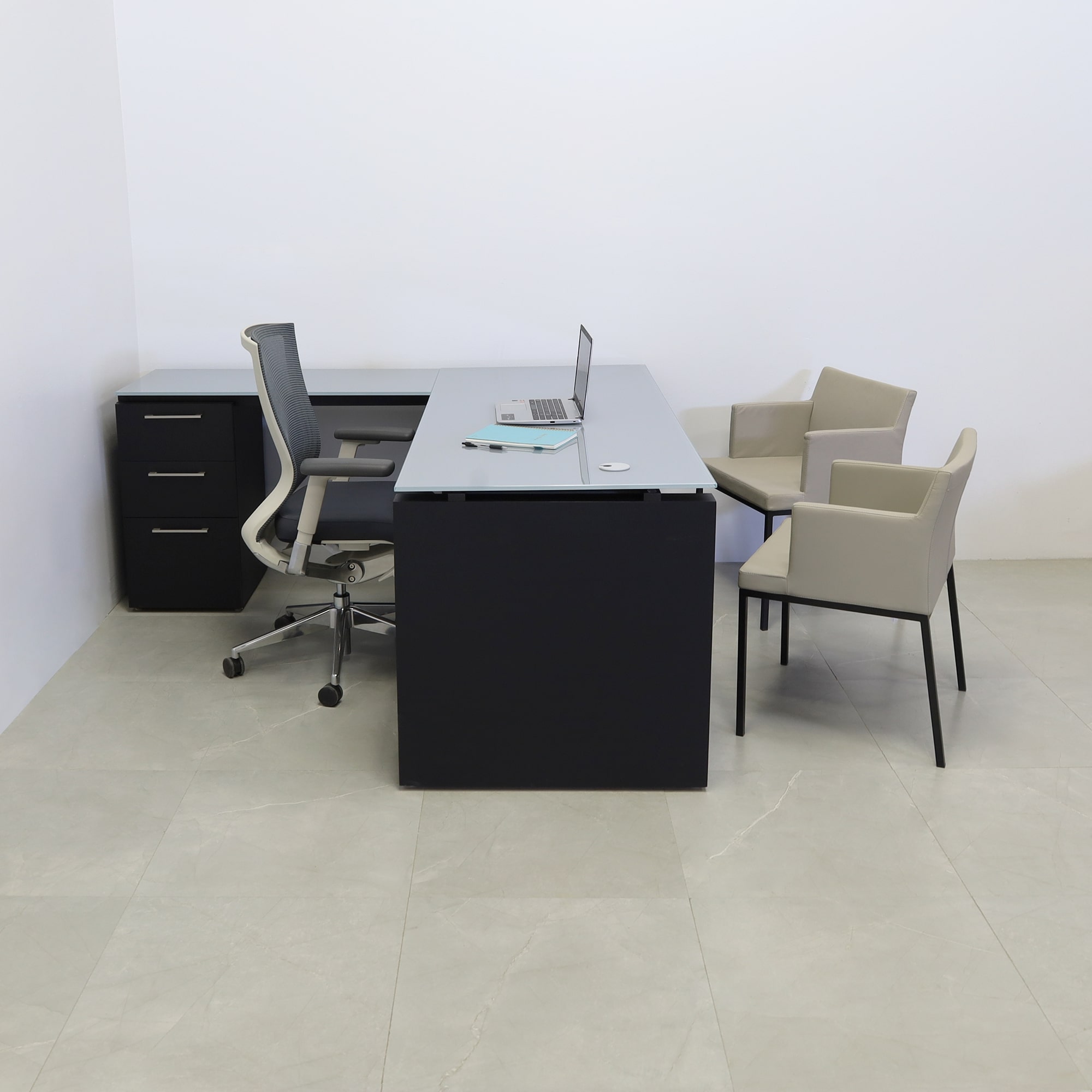 72-inch Denver L-Shape Executive Desk with return & cabinet on the left side when sitting, in 1/2" medium gray tempered glass top, black traceless laminate base, cabinet & privacy panel, shown here.