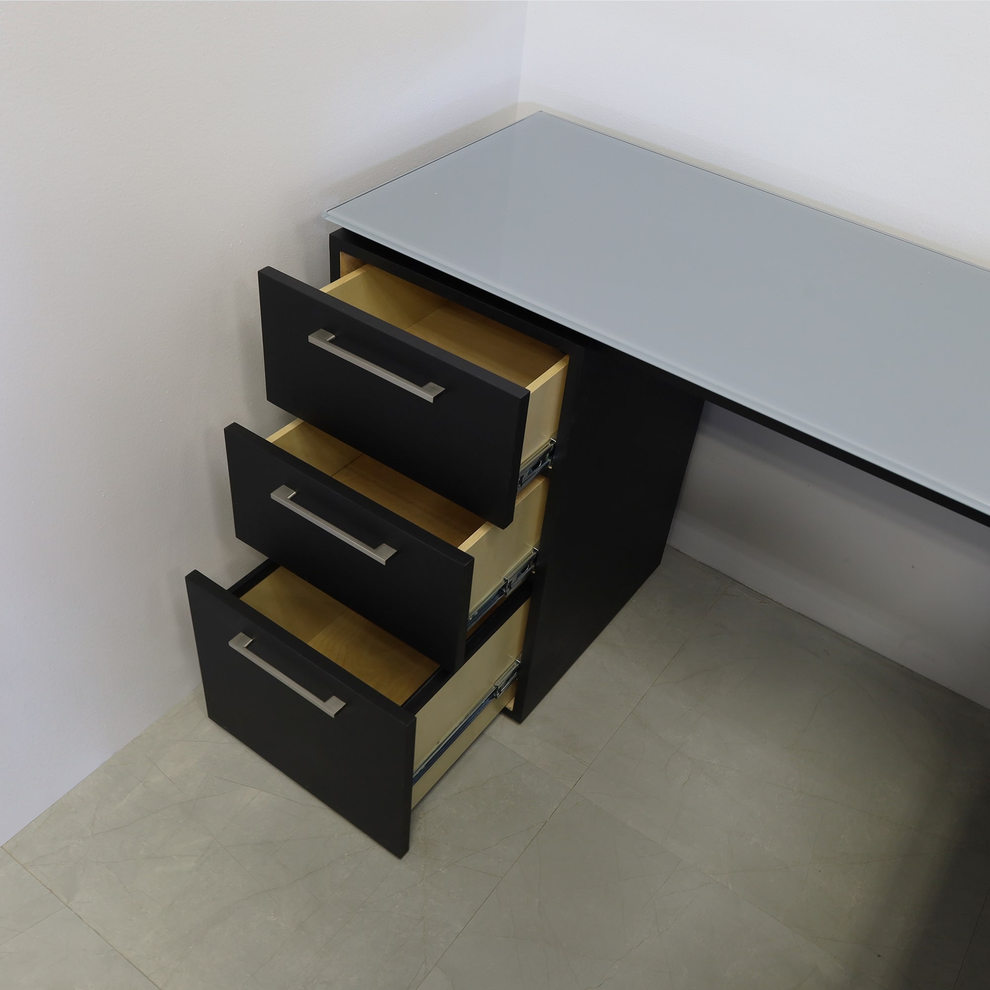 72-inch Denver L-Shape Executive Desk with return & cabinet on the left side when sitting, in 1/2" medium gray tempered glass top, black traceless laminate base, cabinet & privacy panel, shown here.