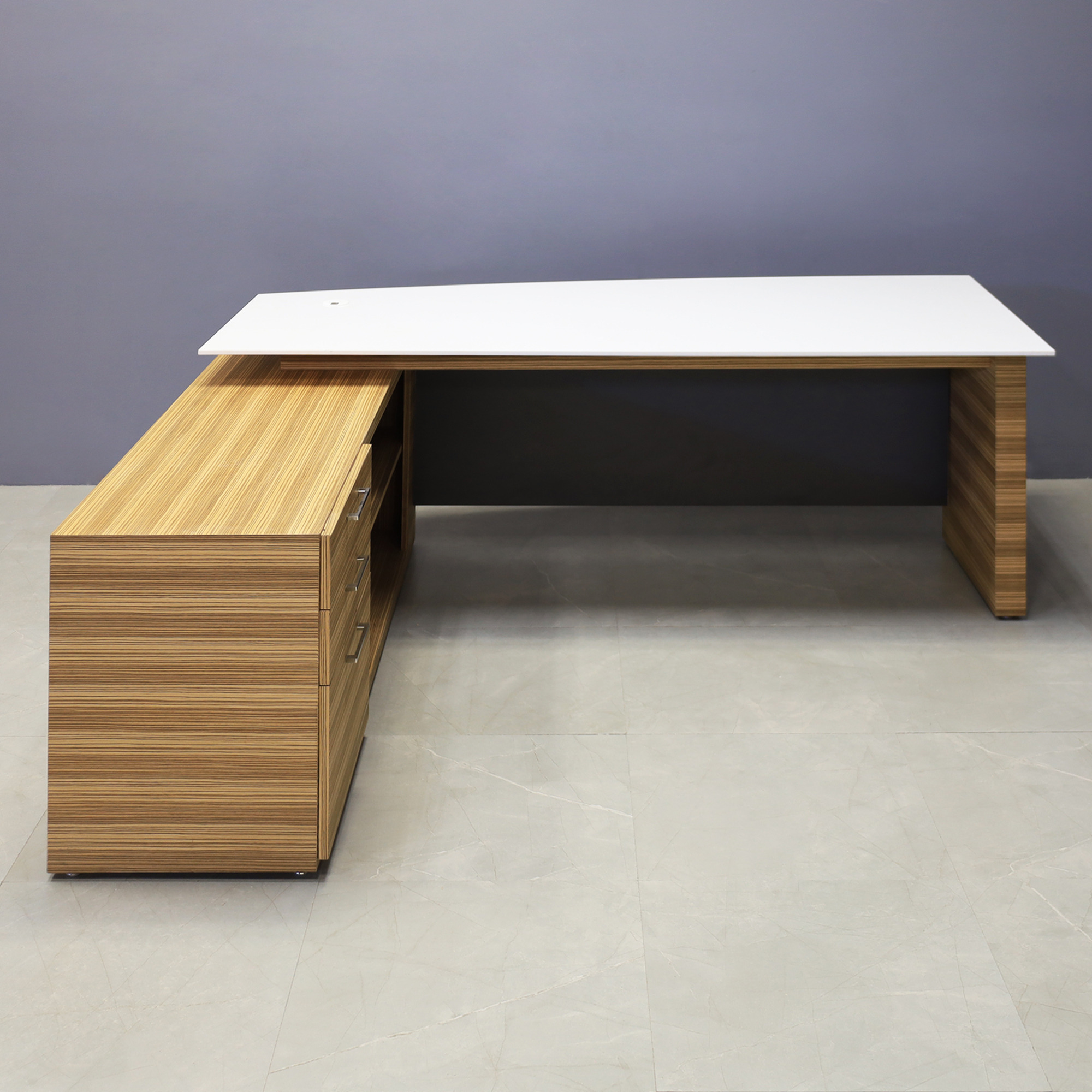 84-inch Avenue Curved Executive Desk with credenza on the left side when sitting, with 1/2" white solid engineered surface top, wood veneer base and credenza, and storm gray matte laminate privacy panel, shown here.