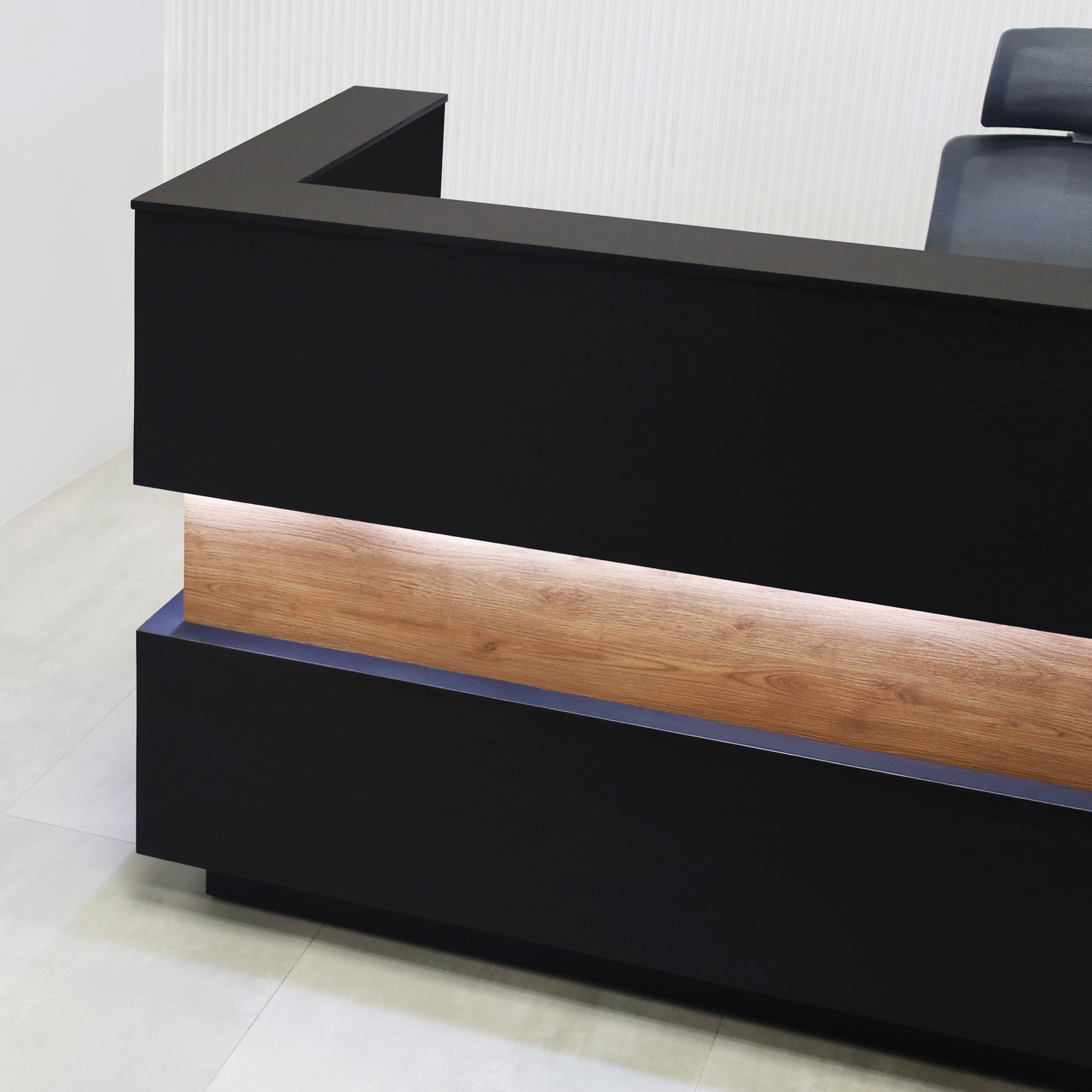 90-inch Pensacola U-Shape Reception Desk with Black Cinder matte laminate desk and toe-kick. Spiced Chestnut laminate accent, Black Traceless engineered surface top, and White LED.