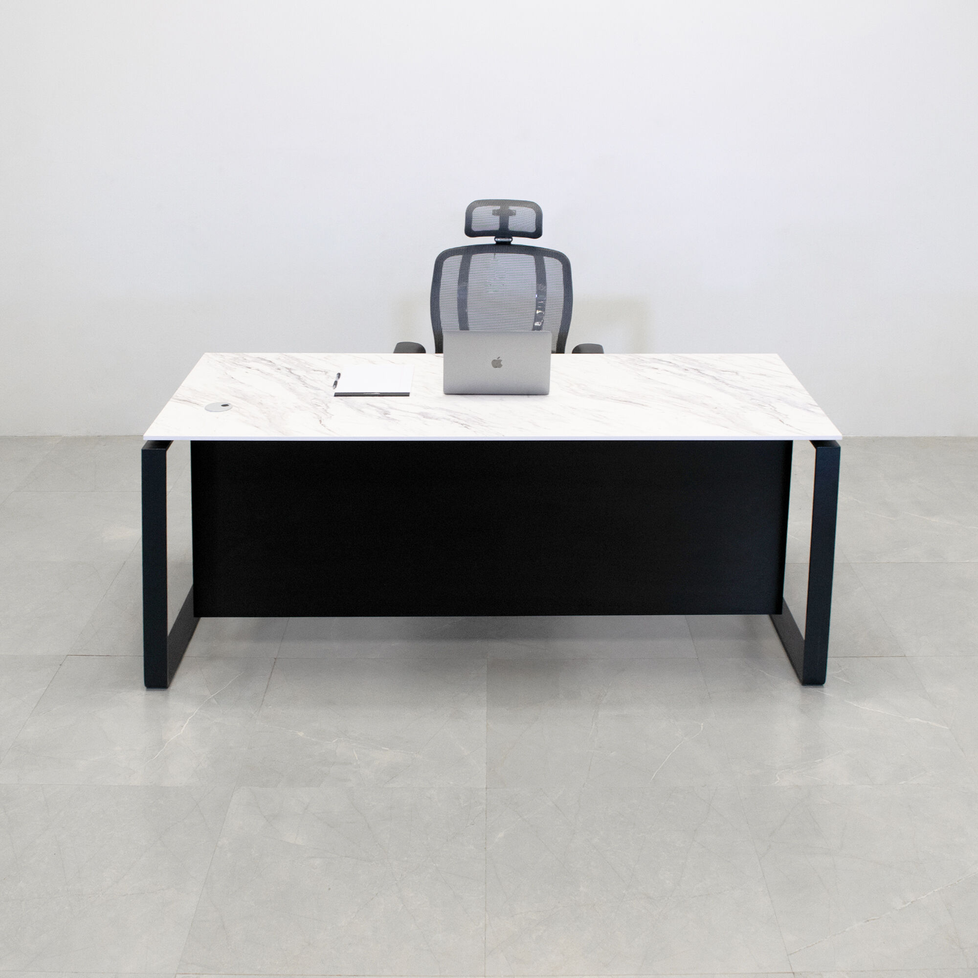 Aspen Straight Executive Desk With 1/2" calcutta blanc engineered surface top, black traceless laminate privacy panel, and black metal legs, shown here.